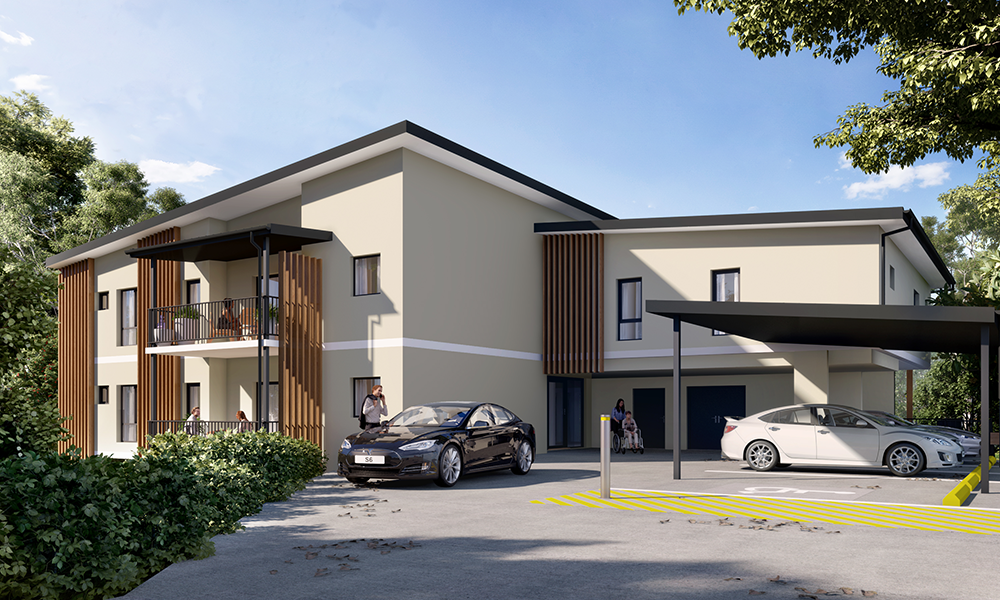 Modern two-story apartment building with balconies, wood panel accents, and a covered parking area. Several cars are parked outside, and a person stands near the entrance, surrounded by trees and greenery.