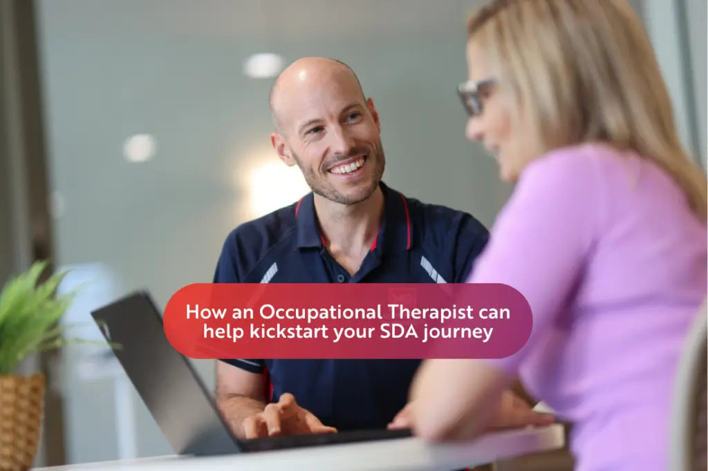 A smiling man and a woman sit at a table with a laptop, talking. Text overlay reads: "How an Occupational Therapist can help kickstart your SDA journey.